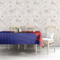 Red and blue Chile crest tablecloth on dining table with white chairs