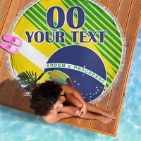 Round Brazil beach blanket with fringe showing toucan, green stripes, blue “00” and “YOUR TEXT”