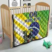 Baby play quilt on light-wood crib, yellow-green diagonal stripes and blue “00 YOUR TEXT”