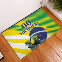 Rubber doormat laid on floor with Brazil flag stripes, toucan, and custom text