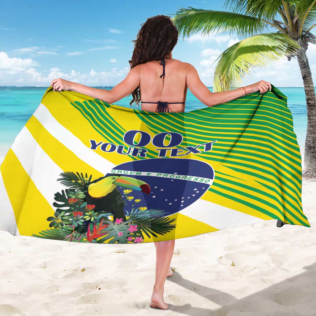 Brazil-themed sarong draped with green/yellow stripes, toucan artwork, and blue emblem on back