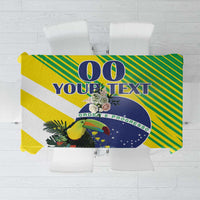 Green and yellow striped tablecloth with blue circular emblem, flowers, and bird graphic