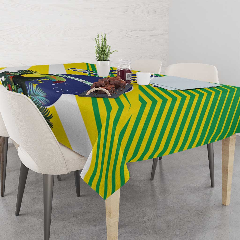 Rectangular tropical tablecloth in green, yellow, and blue with bird, leaves, and stripes