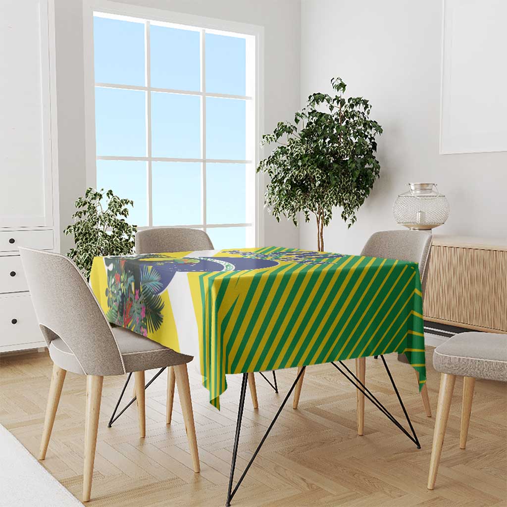 Green and yellow striped tablecloth with blue emblem and tropical foliage print