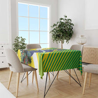 Green and yellow striped tablecloth with blue emblem and tropical foliage print