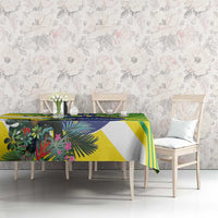 Tropical green, yellow, and blue tablecloth with bird-and-leaf artwork and bold stripes