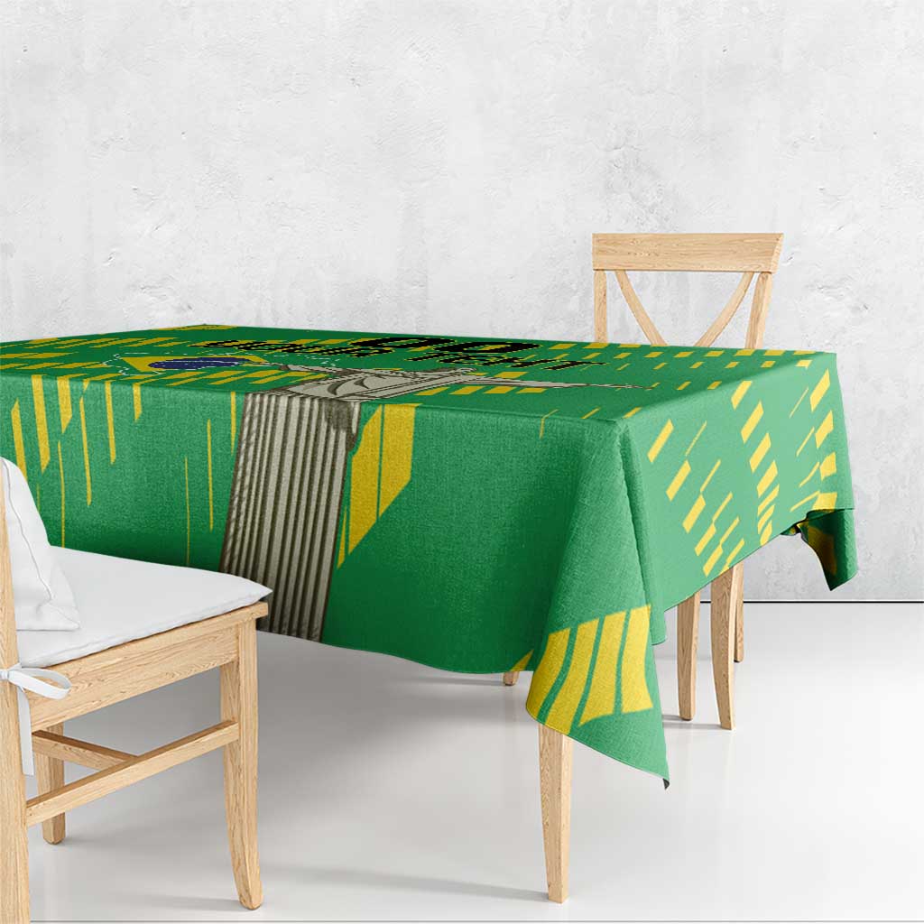 Green tablecloth with yellow Brazil-style stripes and central statue print, draped