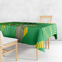 Green tablecloth with yellow Brazil-style stripes and central statue print, draped