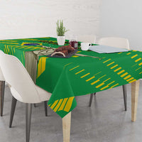 Green tablecloth with yellow stripes and large Cristo Redentor graphic on dining table