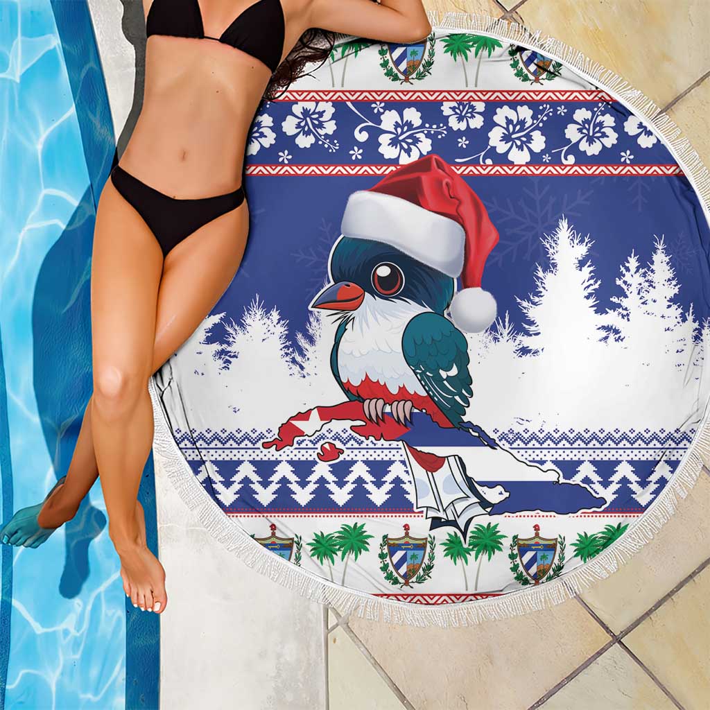 Round blue beach blanket by pool, fringed edge featuring Santa-hat bird artwork