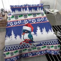 Blue duvet and pillowcases with bird wearing Santa hat, pine trees and trim