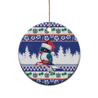 Blue round ceramic Christmas ornament featuring a trogon bird with Santa hat