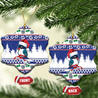 Blue ceramic snowflake-shaped Christmas ornaments with bird in Santa hat, front and back