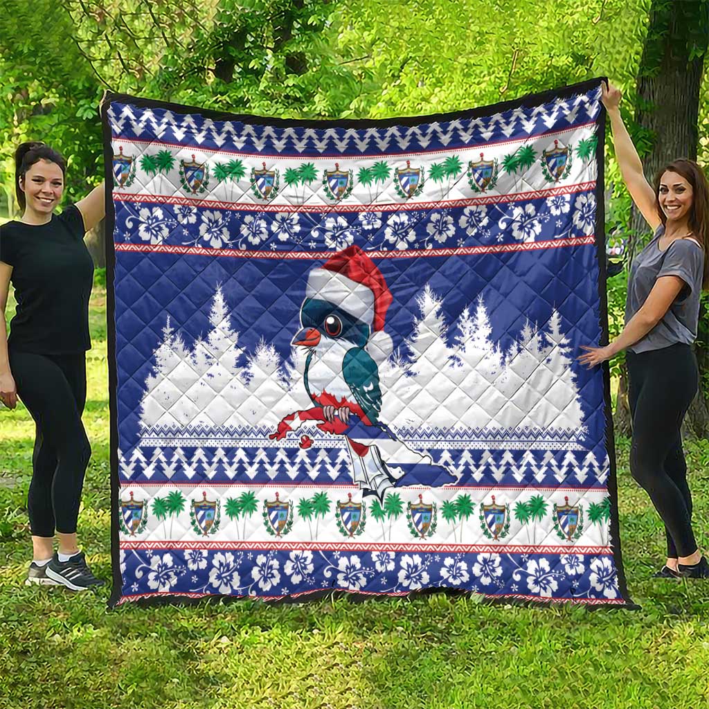 Blue Christmas quilt blanket with bird, pine trees, and colorful holiday trim border