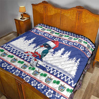 Blue quilt on wooden bed frame featuring bird, pine trees, and festive borders