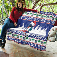 Blue Christmas quilt blanket with bird design, pine trees, and colorful decorative bands