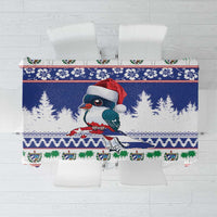 Blue Christmas tablecloth with stylized bird in red hat, trees, and festive border