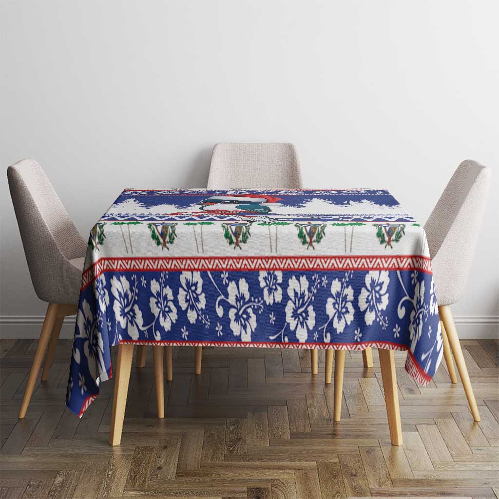 Blue Christmas tablecloth covering table with floral border and red-green accents