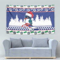 Blue Santa-hat bird Christmas tapestry with pine silhouettes and festive garland border