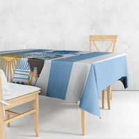 Blue and white striped tablecloth draped over a dining table with printed football theme.