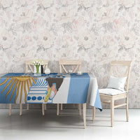 Blue and white custom tablecloth with football-themed sun-and-trophy print on dining table.