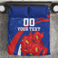 Blue bedding set with matching pillowcases, red flowers, and '00 YOUR TEXT' graphic