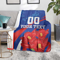 Custom lapageria blanket on floor with blue/red/white design, red flowers, '00 YOUR TEXT'.
