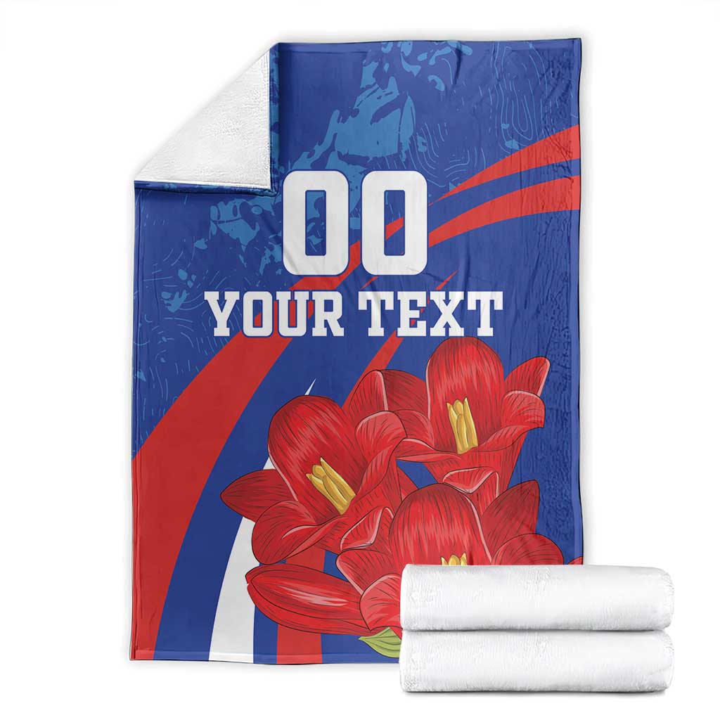 Custom lapageria blanket with folded stack; blue/red/white with red flowers and '00 YOUR TEXT'.