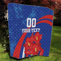 Blue outdoor quilt with red diagonal stripe, red flowers, and "00" plus "YOUR TEXT" on it.