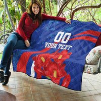 Blue quilt draped outdoors with red diagonal stripe, red flowers, and "00" plus "YOUR TEXT".