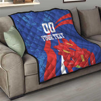 Blue quilt on a couch with red diagonal stripe, red flowers, and "00" plus "YOUR TEXT".