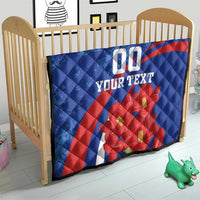 Blue quilt on a toddler bed with red diagonal stripe, red flowers, and "00" plus "YOUR TEXT".