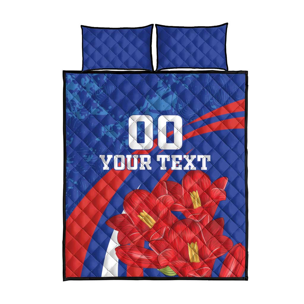 Blue quilt bed set with two matching pillows, red flower graphic and large "DO" text