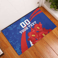 Blue rubber doormat with red stripes, red flower artwork, and custom text