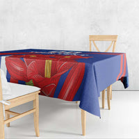 Blue tablecloth with red lily flower print and yellow accents, grunge style.