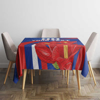 Blue tablecloth with red floral centerpiece design and custom text banner.