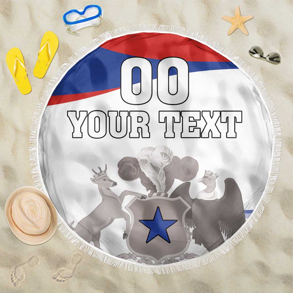 Round white beach blanket with Chile flag stripes, coat of arms graphic, and fringe edge