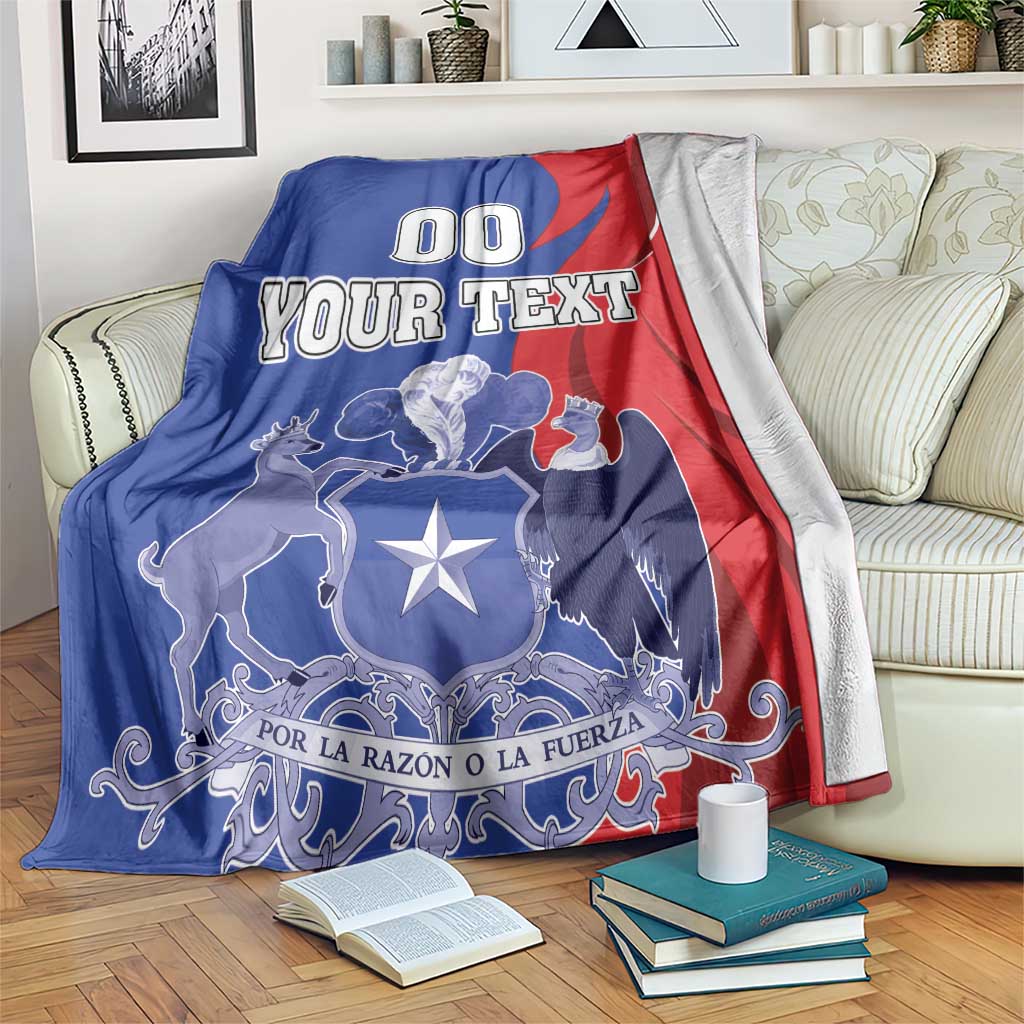 Blue and red throw blanket with coat of arms graphic and 'YOUR TEXT' on a couch