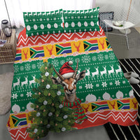 Christmas bedding set with green Springbok face in red hat, tree and deer pattern