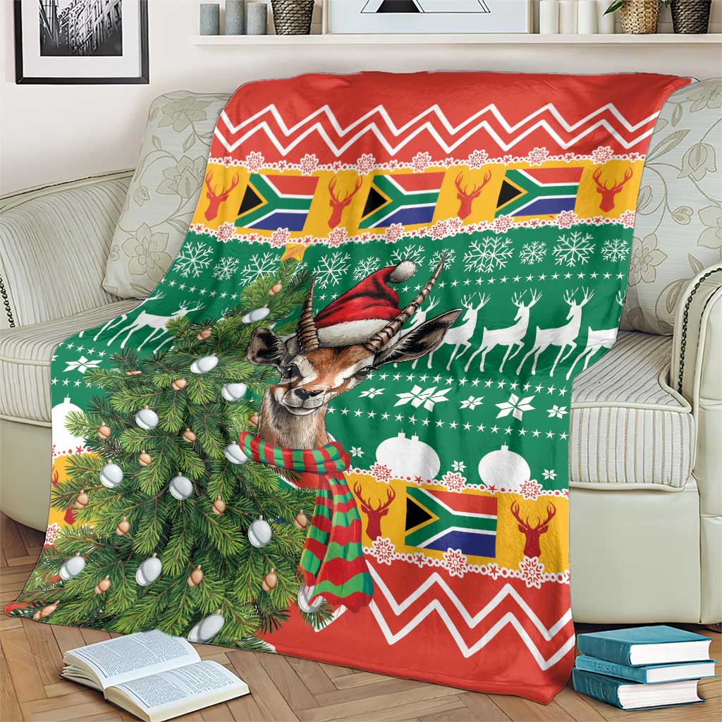 Christmas blanket on couch, green and red springbok design with Christmas ornaments and zigzags