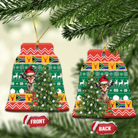 Bell-shaped ceramic Christmas ornament set with springbok in red hat and festive green pattern