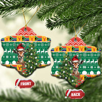 Bell-shaped ceramic Christmas ornament with springbok in red hat on green festive pattern