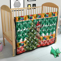 Christmas quilt blanket on toddler bed: green tree pattern, springbok, and red zigzag border