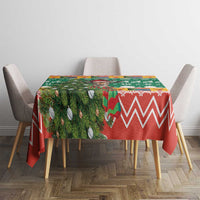 Christmas tablecloth on dining table, green foliage and red zigzag pattern with ornaments