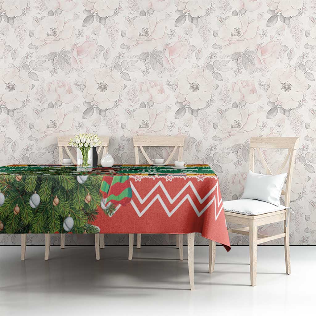 Christmas tablecloth on dining table, green foliage with red zigzag design