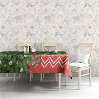 Christmas tablecloth on dining table, green foliage with red zigzag design