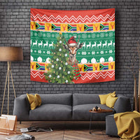 Christmas tapestry with springbok wearing a red hat, green and red festive holiday pattern