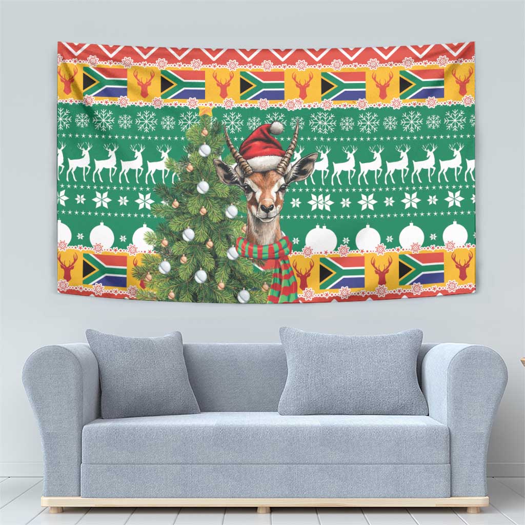 Christmas wall tapestry showing a springbok in a striped scarf, holiday symbols and red zigzag trim