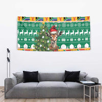 Rectangular Christmas tapestry with springbok face, green pattern, white snowflakes and red border