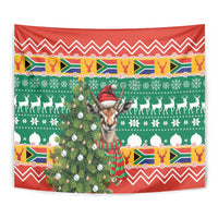 Close view Christmas tapestry with springbok in red hat and scarf, green and red holiday motif